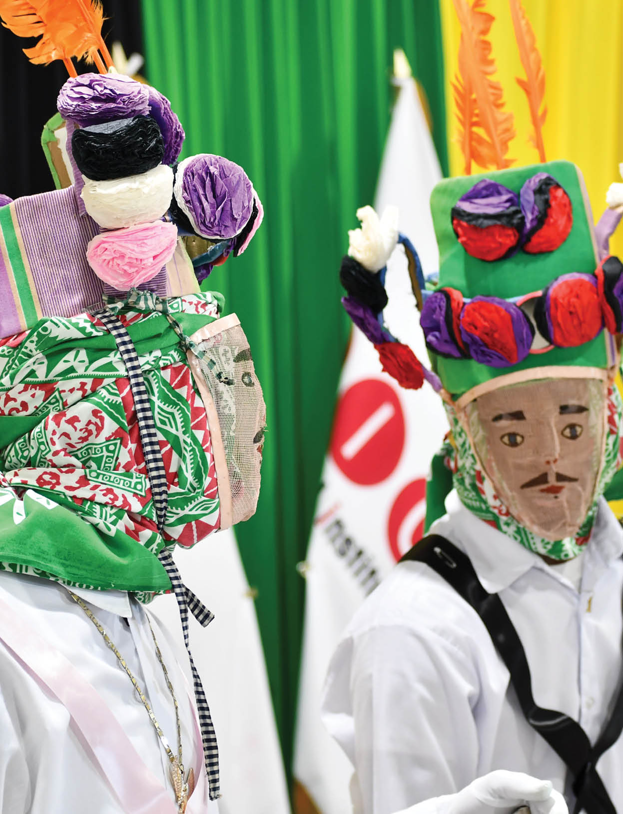 Two people wearing masks with flowers on them. Description generated by AI