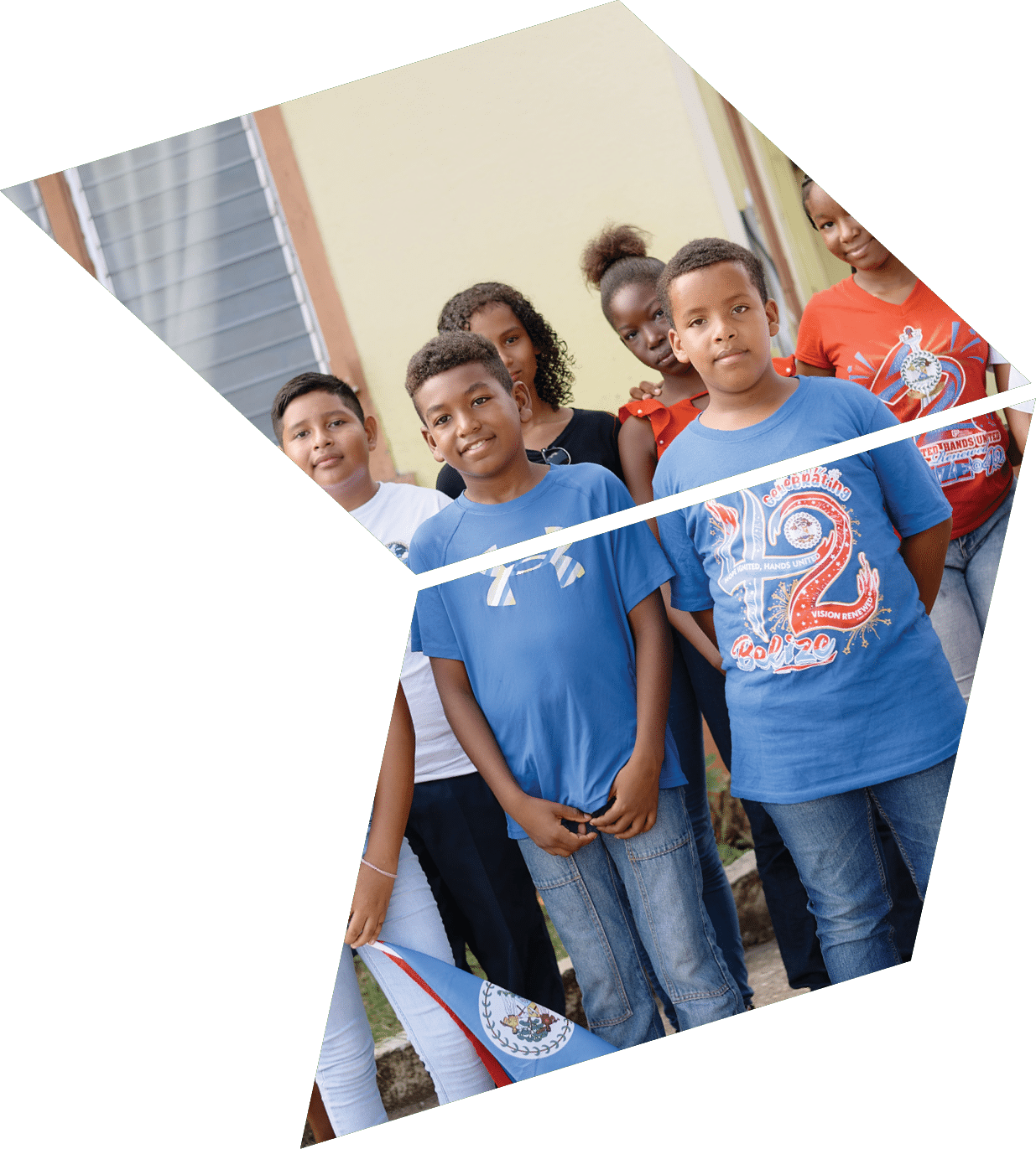 A group of young people standing in front of a building. Description generated by AI