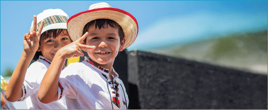 Two children wearing hats and shirts. Description generated by AI