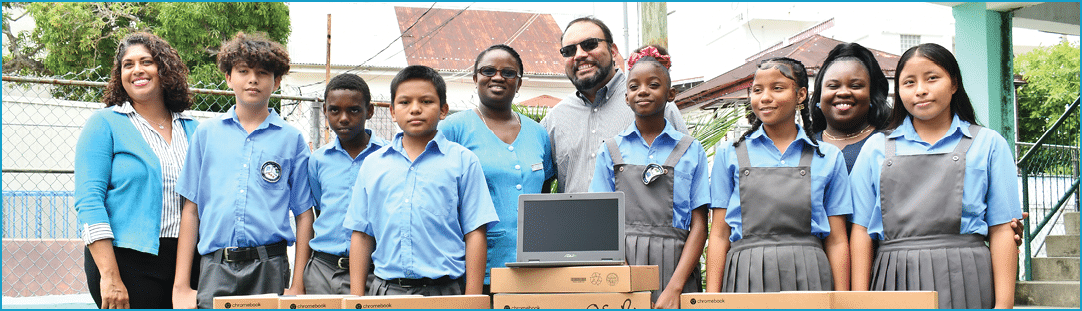 A group of children standing in front of boxes. Description generated by AI