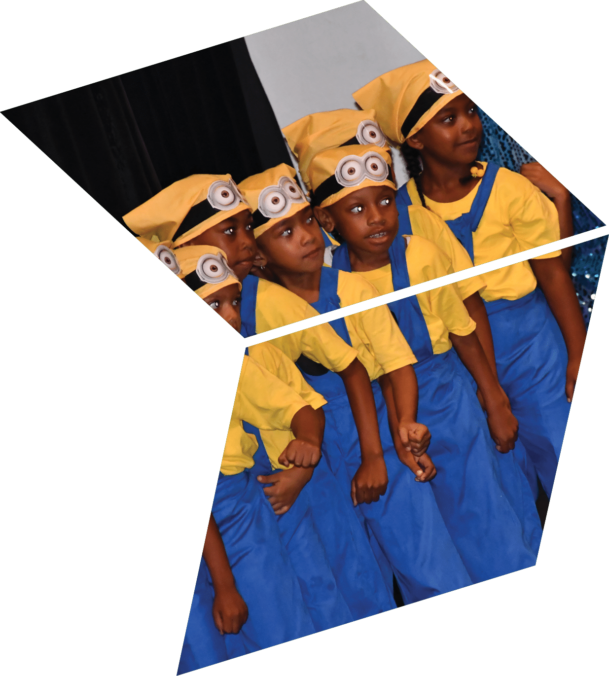A group of children wearing yellow hats and blue overalls. Description generated by AI