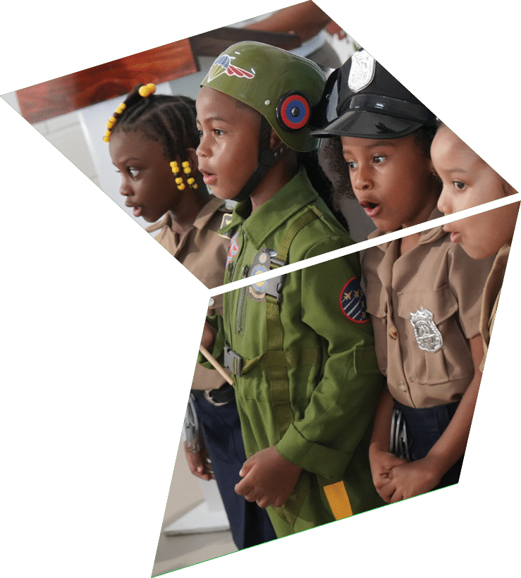 Four children wearing uniforms and holding flags. Description generated by AI